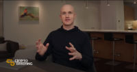 Brian Armstrong, CEO of Coinbase, gesturing with his hands while speaking.