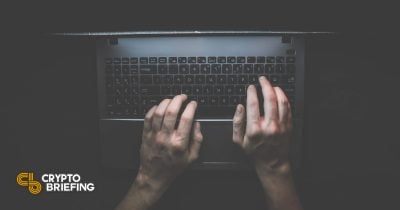 Person typing on a notebook computer keyboard in a dimly lit atmosphere, illustrating security vulnerability and privacy concerns.