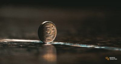 Indian rupee coin on a brown table.