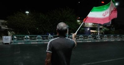 Iranians in London hold vigil for Sen. Graham, wave pre-revolutionary Iran flag
